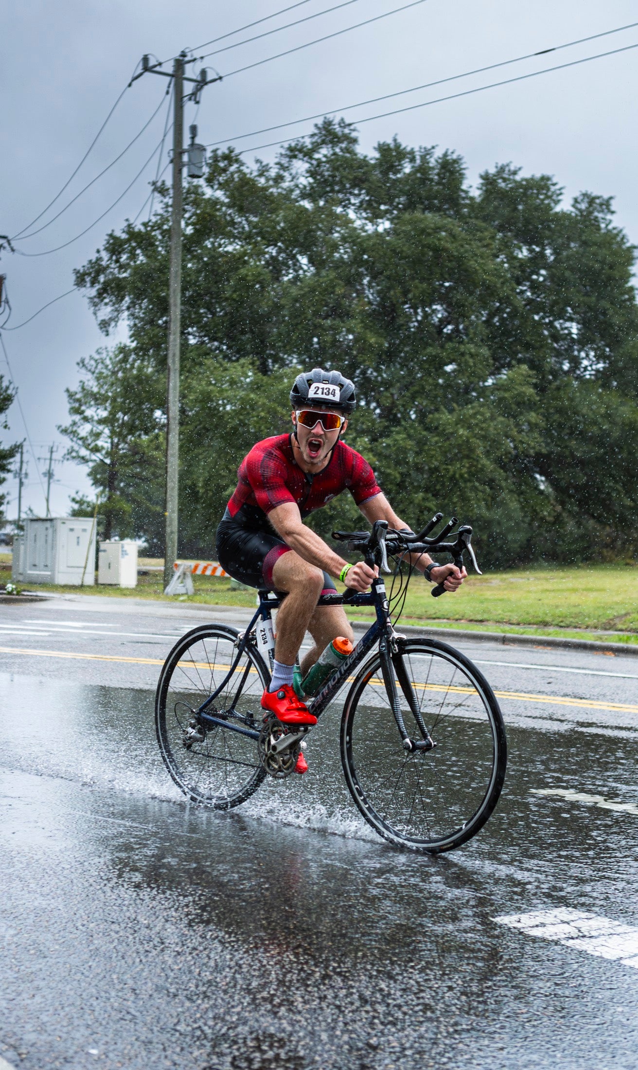 Cyclist racing on a wet road